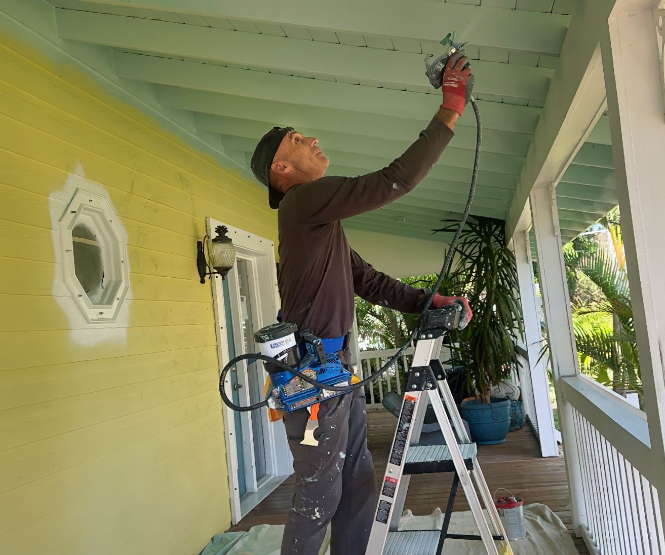 Professional painter in Melbourne, FL applying fresh coat to home exterior